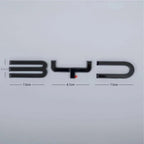 Black BYD emblem with chrome accents and dimensions showing 3.4cm height and 23.7cm width.