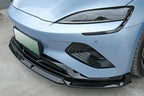 Glossy black aerodynamic front lip spoiler installed on a light blue BYD car bumper.