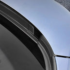 Close-up of a durable black matte plastic car door sill protector on a light blue vehicle.