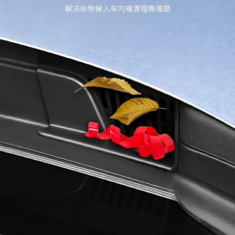 Red protective plastic trim preventing debris and leaves from entering car vents.