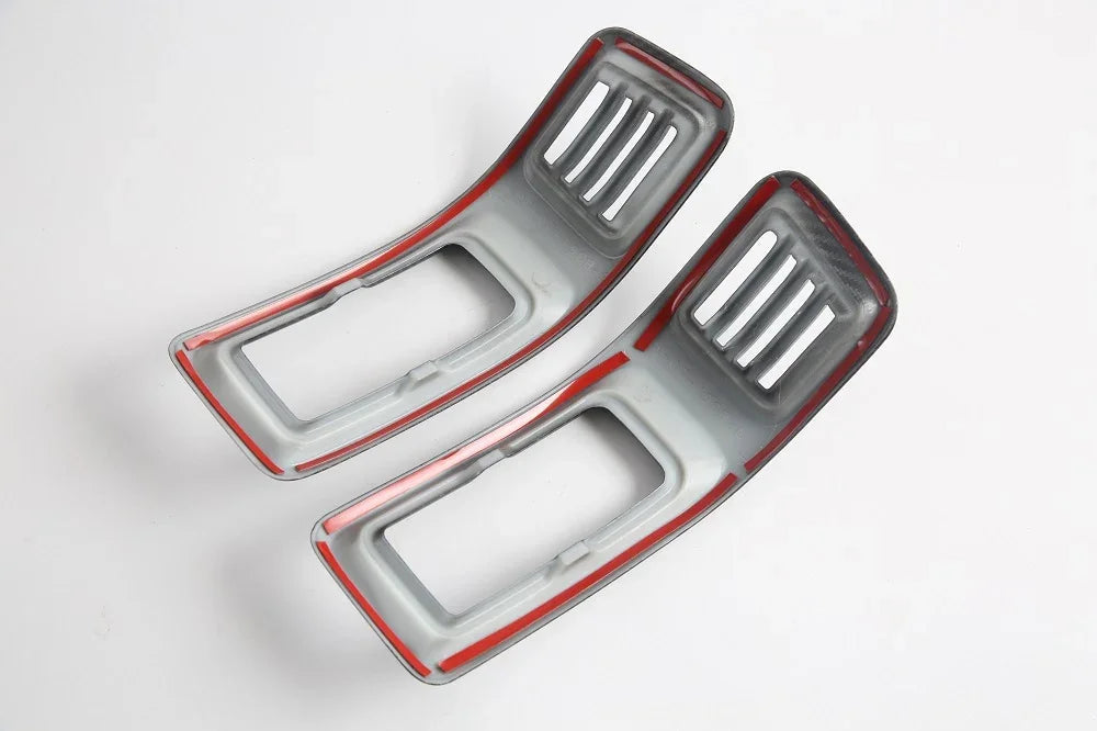 Pair of grey carbon fiber texture interior trim pieces with vibrant red accent borders.