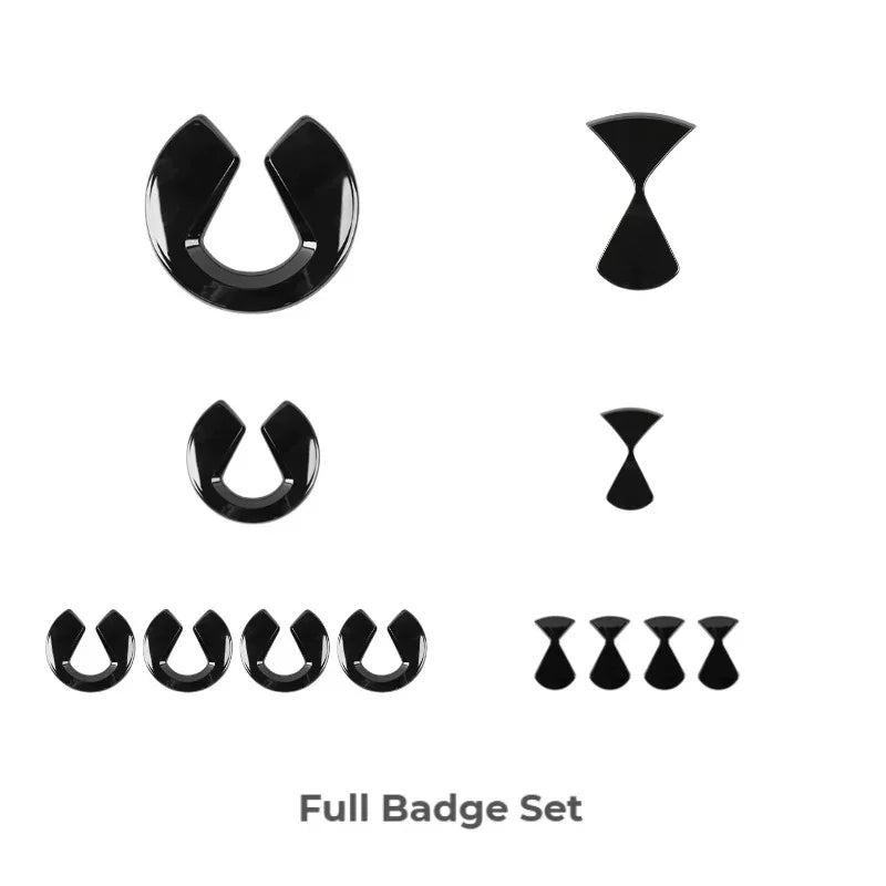 Glossy black emblem badge set featuring various sizes for car exterior customization.
