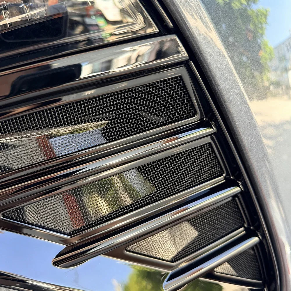 Glossy black chrome grille with fine metallic mesh texture for BYD vehicle protection.