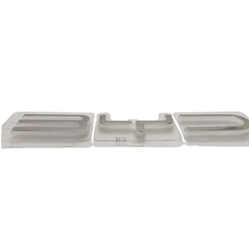 Silver metallic BYD emblem letters for car exterior decoration.