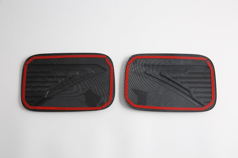 Black carbon fiber texture door sill protector plates with distinctive red trim edges.