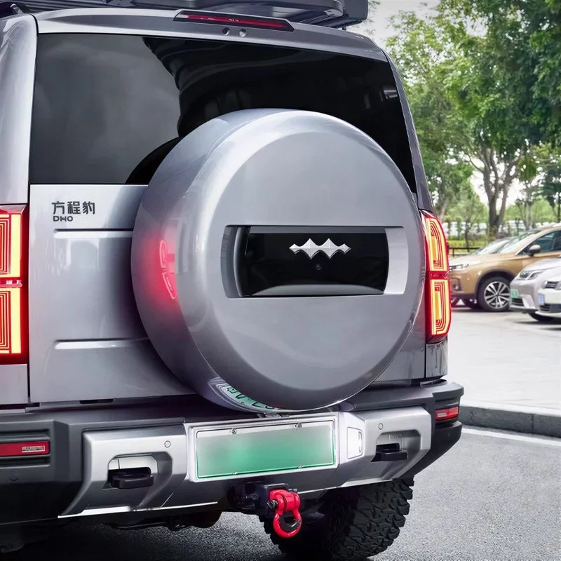 Silver metallic spare tire cover with black central accent for BYD Fang Cheng Bao SUV.