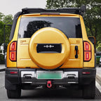 Yellow BYD off-road SUV rear view featuring a matching hard-shell spare tire cover and roof rack.