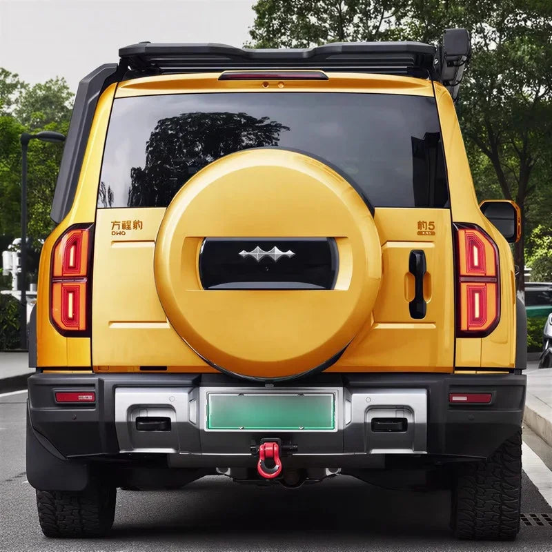 Yellow BYD off-road SUV rear view featuring a matching hard-shell spare tire cover and roof rack.