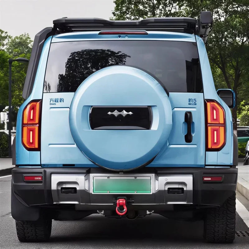 Rear view of a light blue BYD FangChengBao 5 SUV featuring a matching hard spare tire cover.