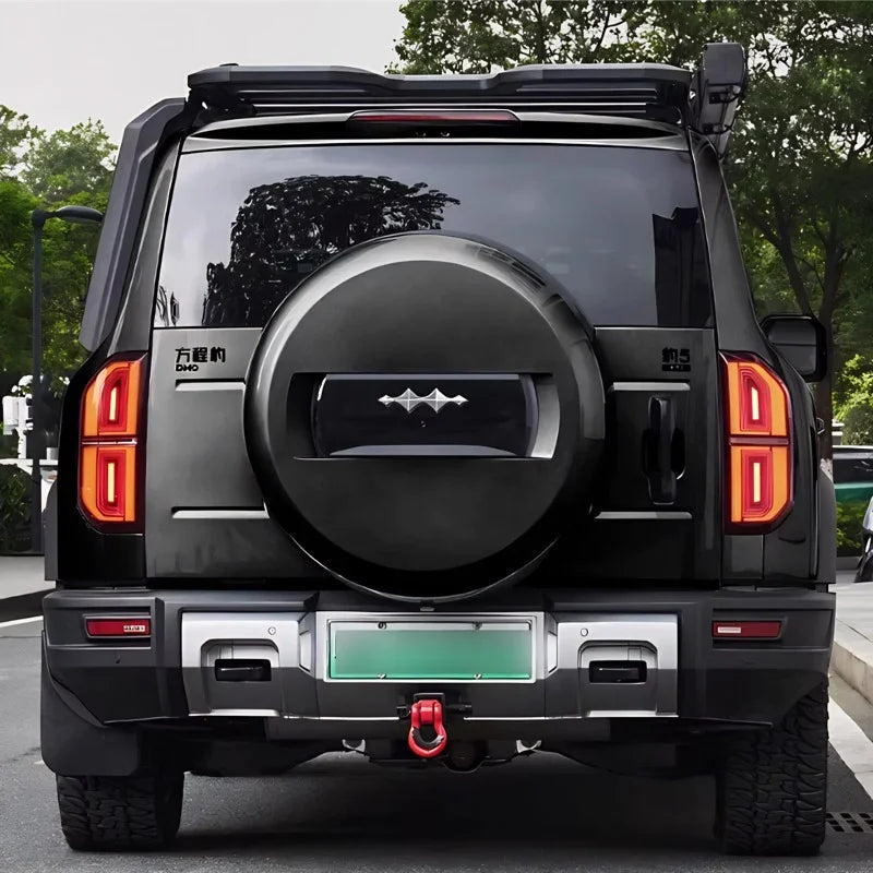 Rear view of a black BYD FangChengBao off-road SUV featuring a matte black spare tire cover.