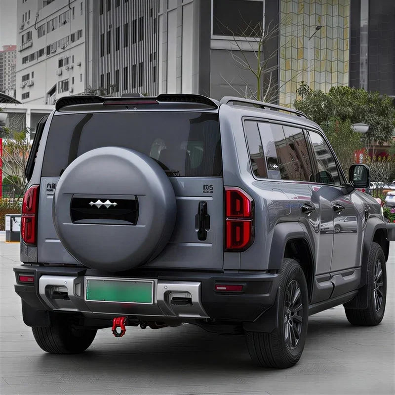 Grey BYD Tang SUV featuring a custom matte grey spare tire cover and rugged rear bumper design.