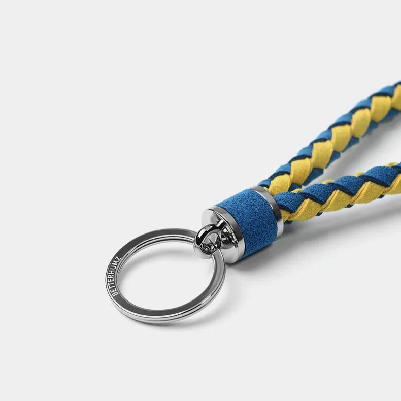 Braided blue and yellow leather keychain with a polished silver metal ring.