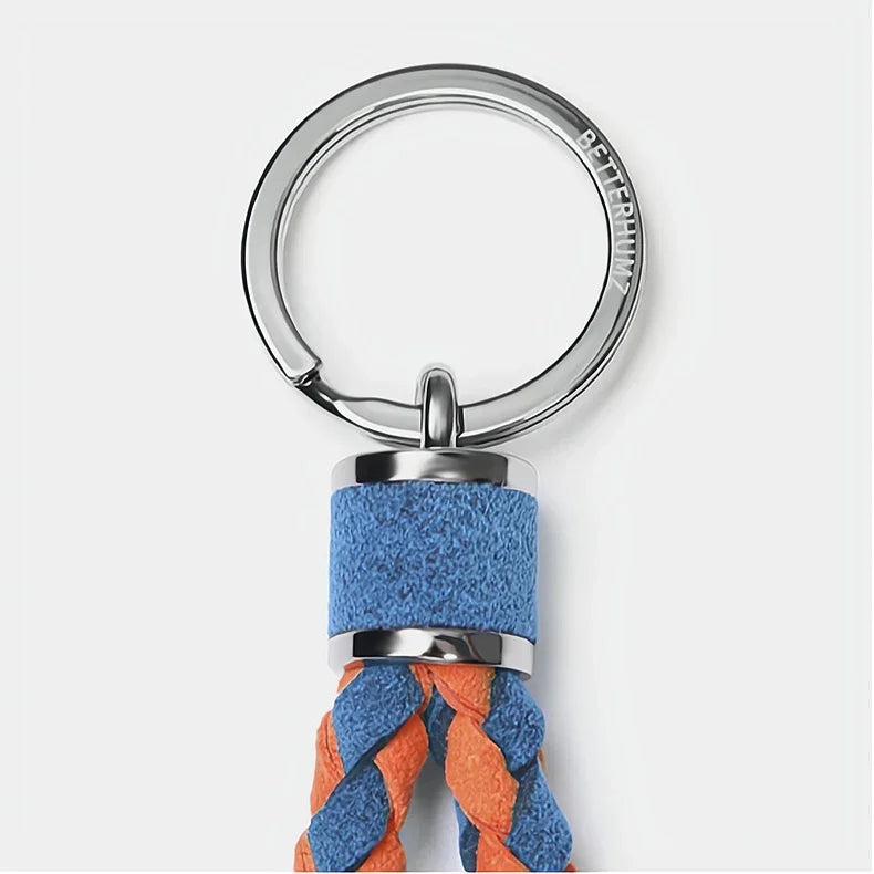Braided blue and orange suede leather keychain with a polished silver metal ring.