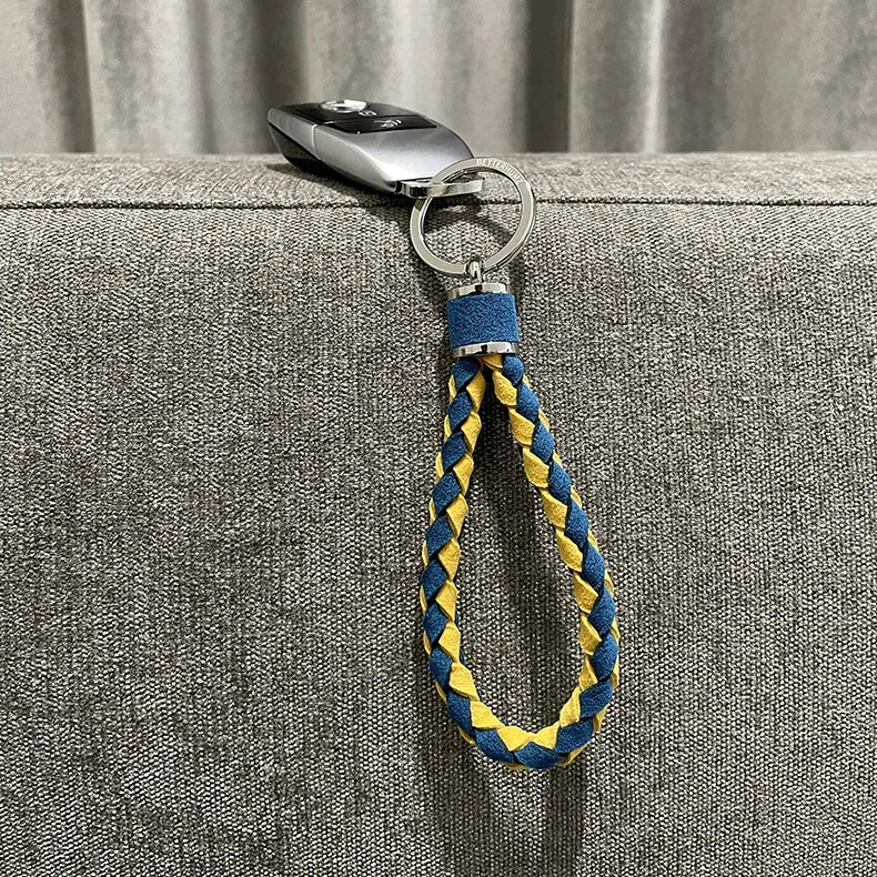 Braided blue and yellow fabric keychain loop attached to a silver car key fob.