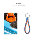 Braided Alcantara keychain in blue and orange, featuring a premium textured finish.