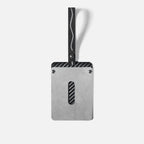 Silver metal car accessory with carbon fiber accents and a black strap.