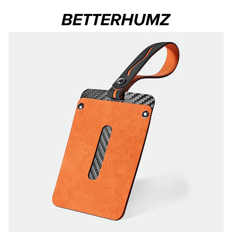 Premium orange suede and carbon fiber pattern car key fob cover with a durable wrist strap.