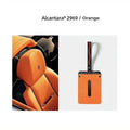 Orange Alcantara car interior seat with premium texture and carbon fiber accents.