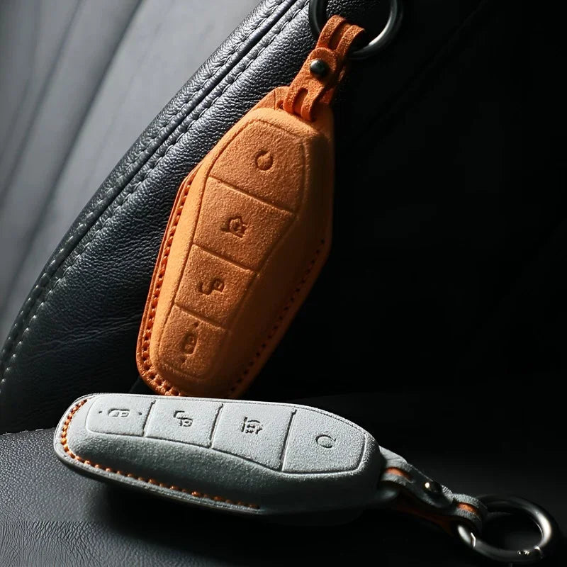 Premium orange and grey suede leather car key fob covers with precise stitching.
