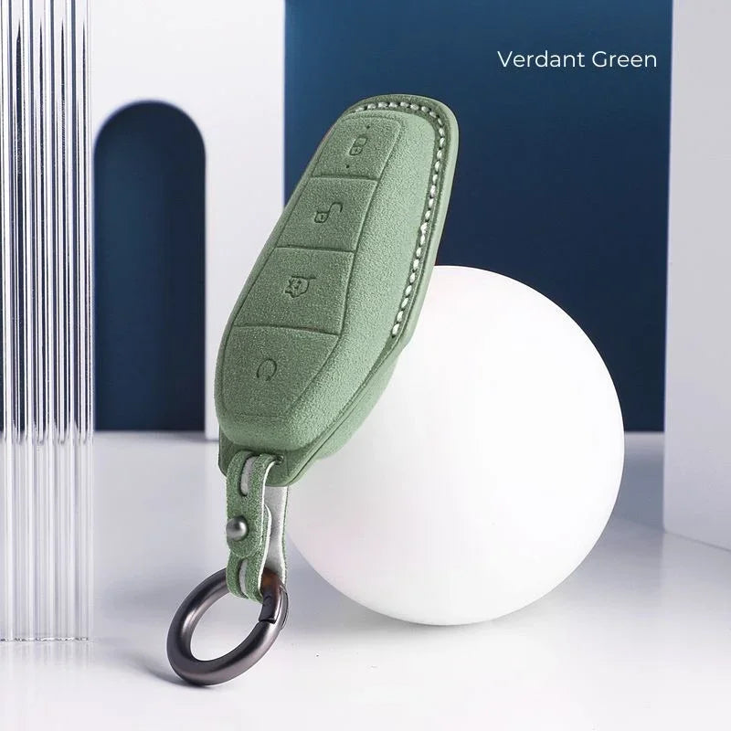 Verdant green premium faux leather car key fob cover with precise stitching and metal ring.