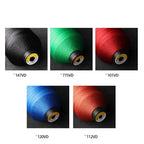 Assorted spools of durable upholstery sewing thread in black, green, red, blue, and orange.