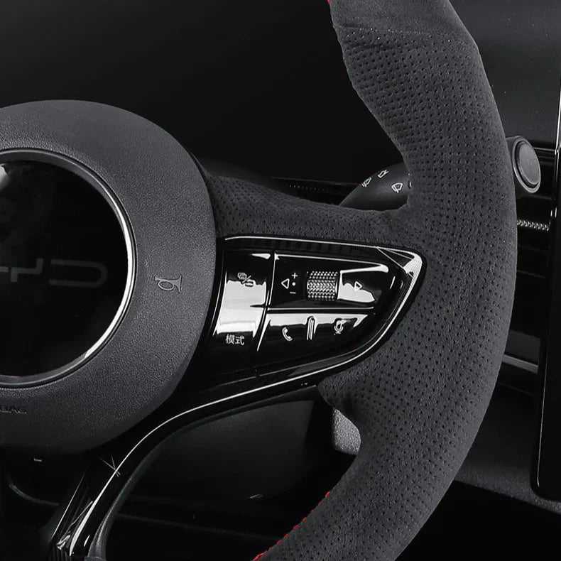 Black perforated leather steering wheel cover with red stitching for BYD aftermarket upgrade.