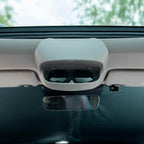 Grey overhead car console featuring a built-in sunglasses storage compartment.