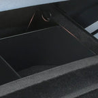 Close-up of a black matte finished storage compartment with a durable textured trim.