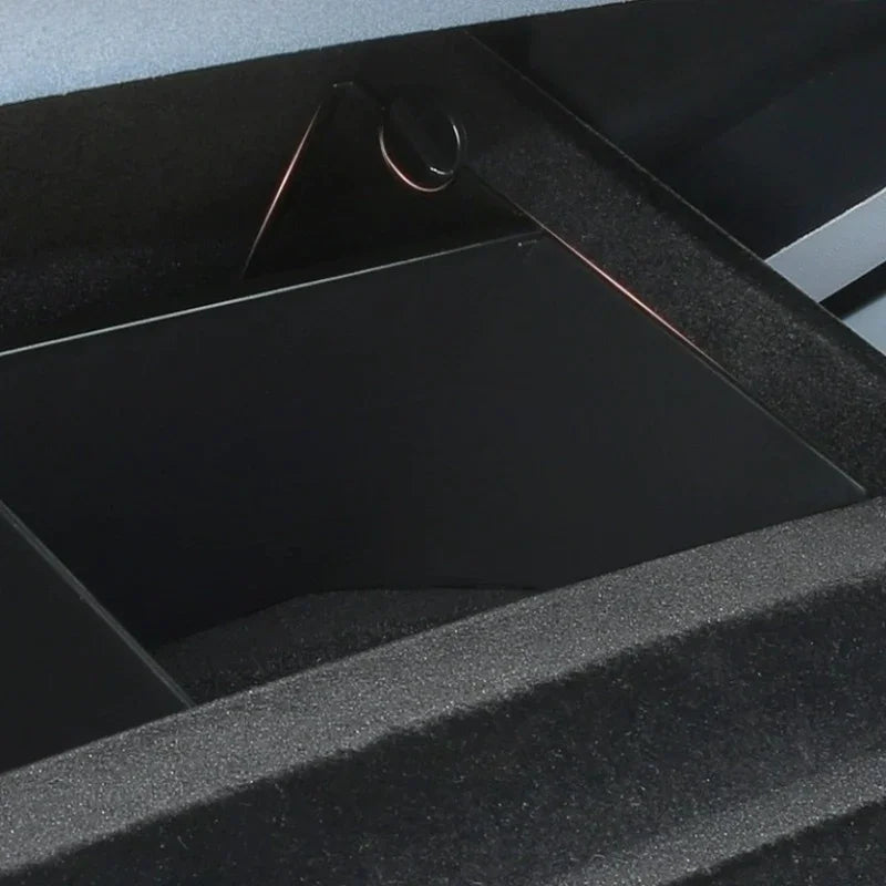 Close-up of a black matte finished storage compartment with a durable textured trim.