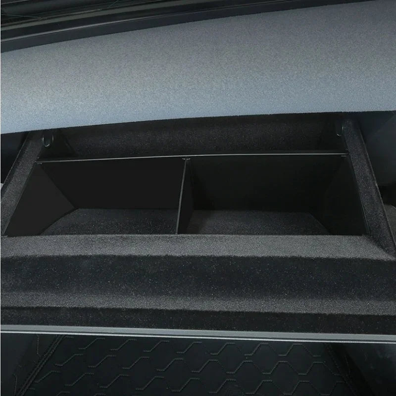 Black carpeted car trunk organizer with dividers for durable interior storage.