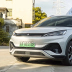 Front view of a sleek silver electric vehicle with a green license plate.