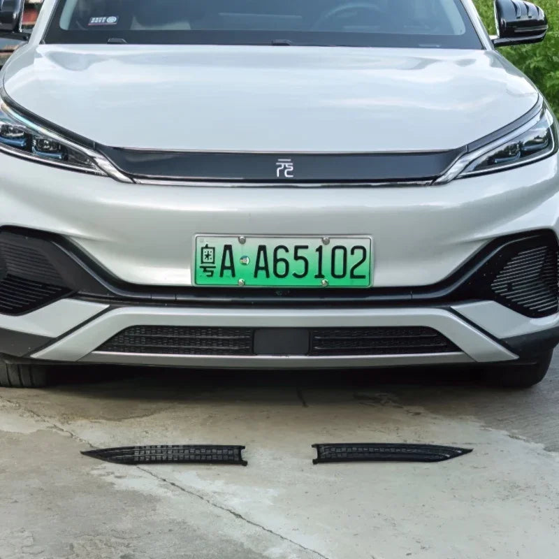 Black textured anti-slip door sill protectors for white BYD vehicle front bumper area.