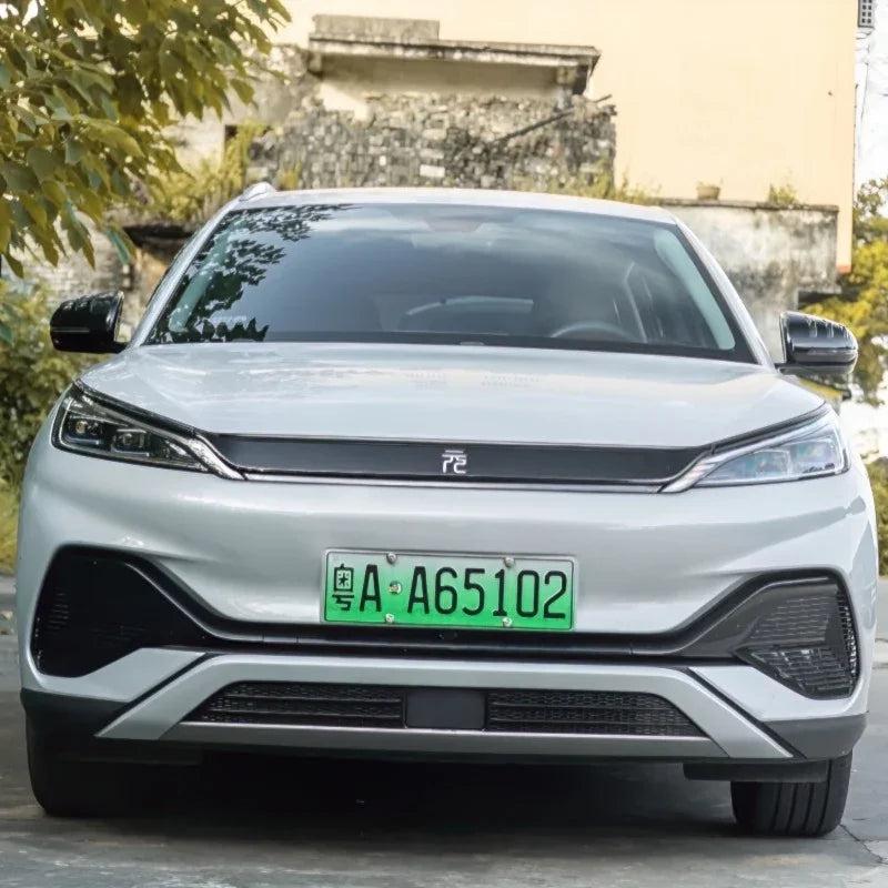 Front view of a white BYD electric vehicle featuring sleek LED headlights and a black grille.