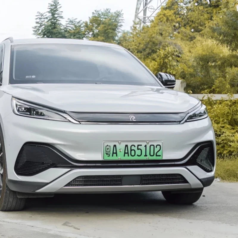 Front view of a sleek silver electric SUV with a green Chinese license plate.