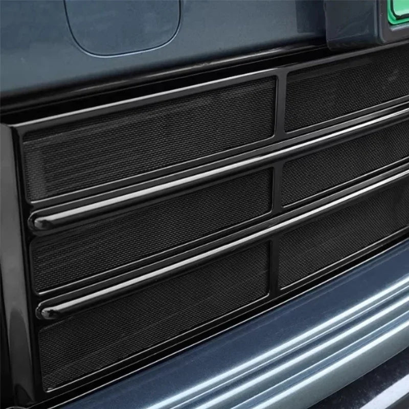 Black textured mesh protective grille cover for car interior trim.