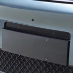 Matte black license plate frame mounted on a silver BYD vehicle bumper.