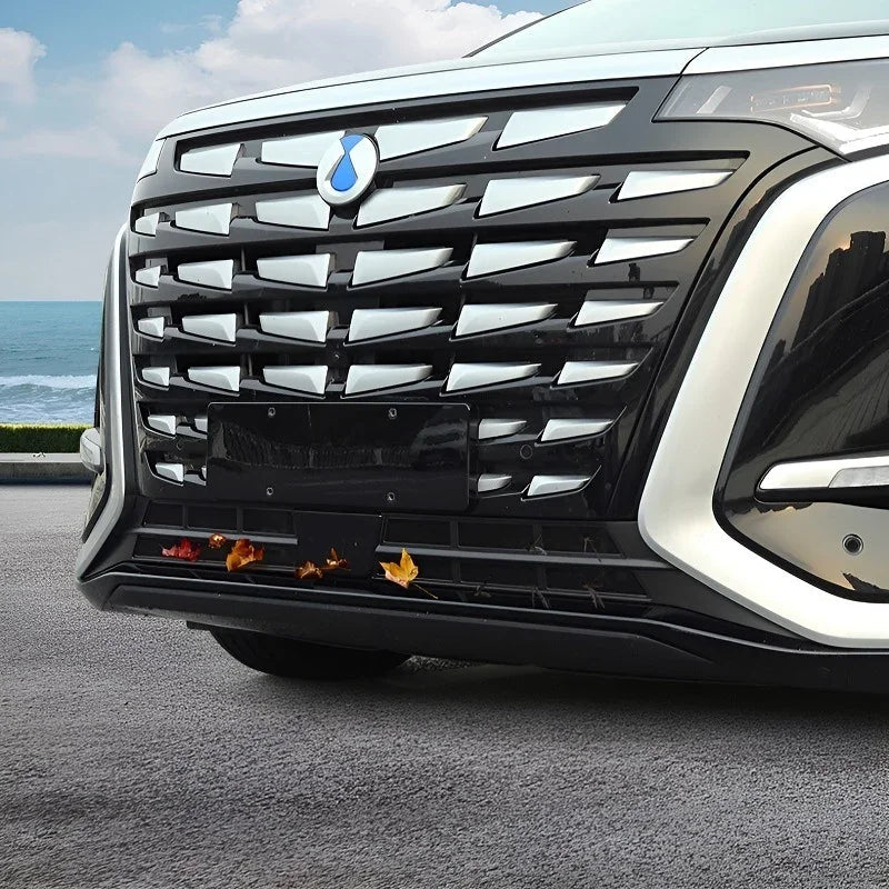 Front view of a black car featuring a premium chrome-accented wide grille and sleek headlights.