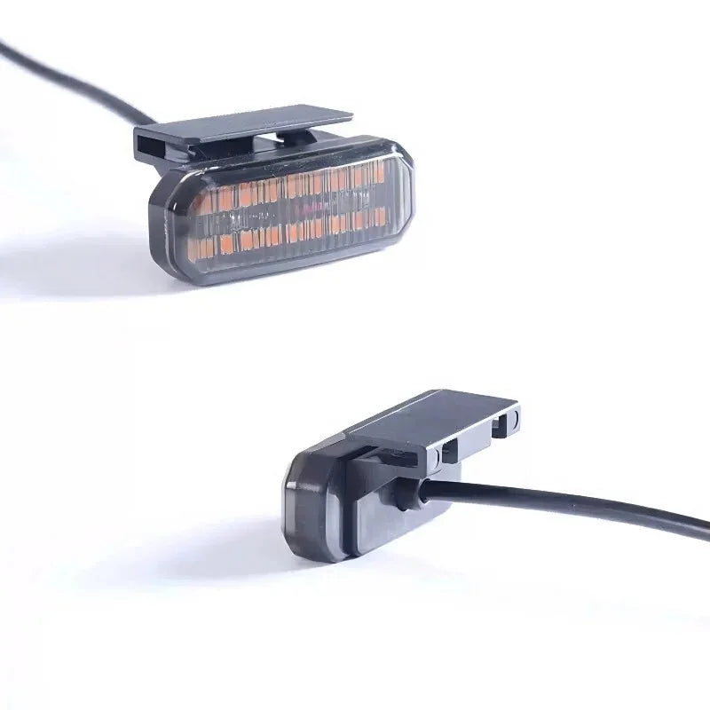 Two black plastic LED car lighting components with amber-colored light arrays and wiring.