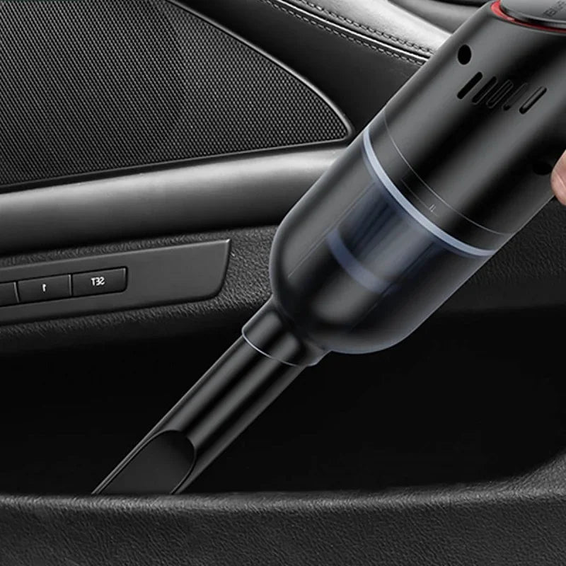 Black handheld cordless car vacuum cleaner cleaning a dark car door pocket.