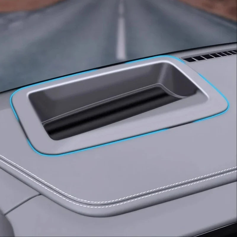 Grey leather car console tray with precision stitching and integrated blue ambient lighting.