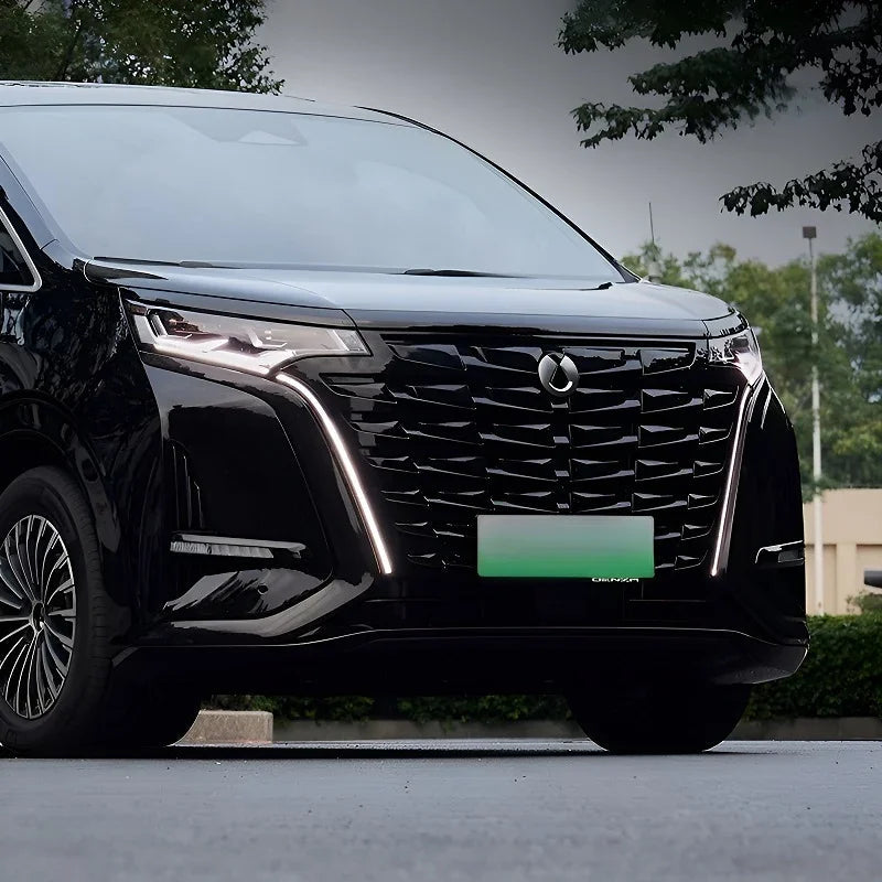 Front view of a glossy black BYD Denza luxury MPV featuring a prominent chrome grille.
