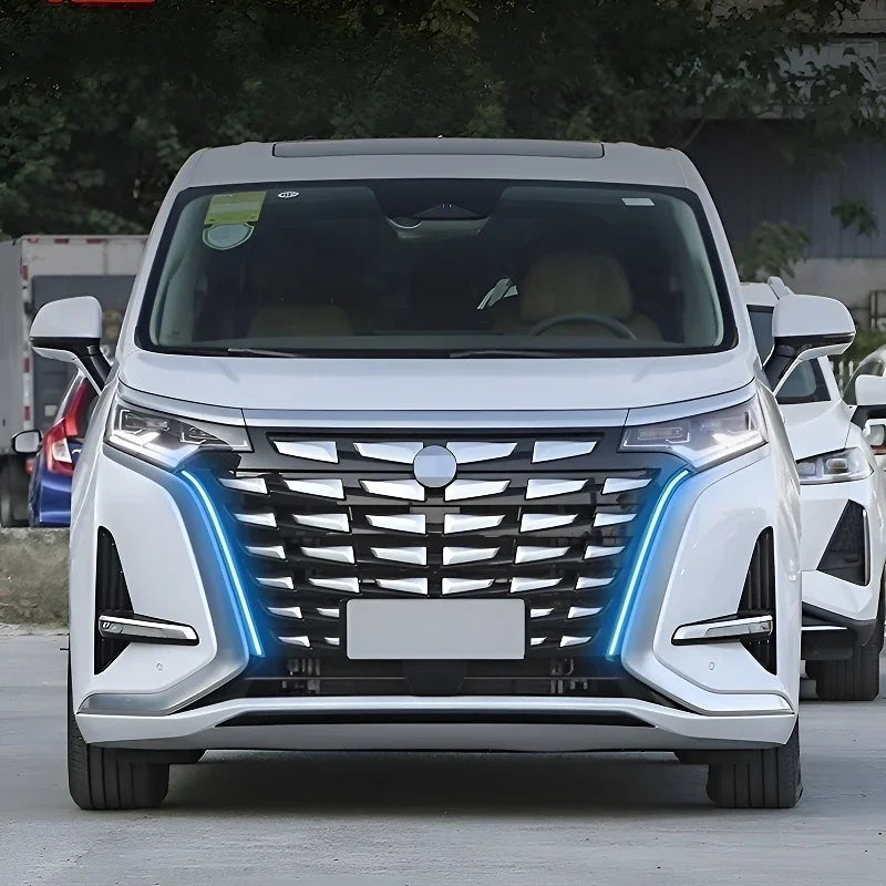 Front view of a white electric vehicle with a distinctive chrome grille and blue LED accents.