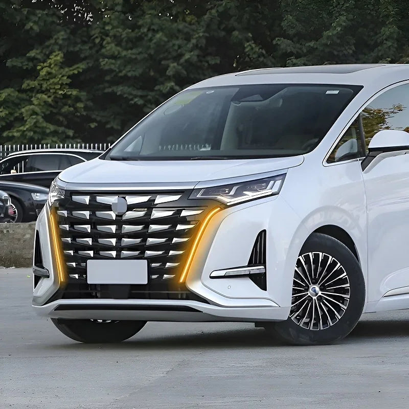Front view of a white BYD electric minivan featuring sleek LED headlights and a modern chrome grille.