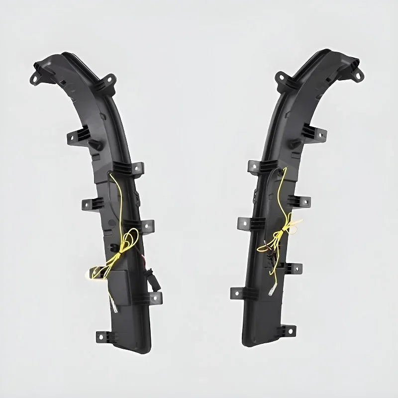 Pair of professional black plastic side skirts with integrated yellow wiring harnesses.