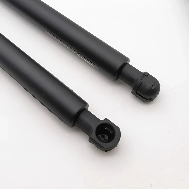 Pair of durable matte black automotive gas struts for car trunk or hood support