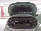 Open hood of a sage green BYD electric vehicle showing the detailed engine bay and components.