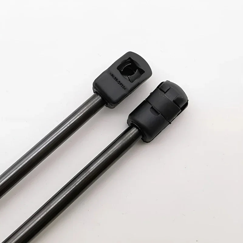 Two black metal rods with specialized square and rounded plastic end connectors.