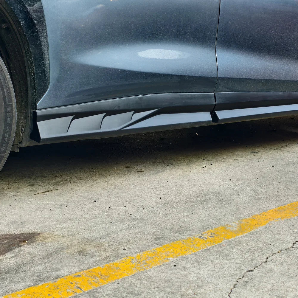 Matte black aerodynamic side skirt extension for BYD, made of durable composite material.