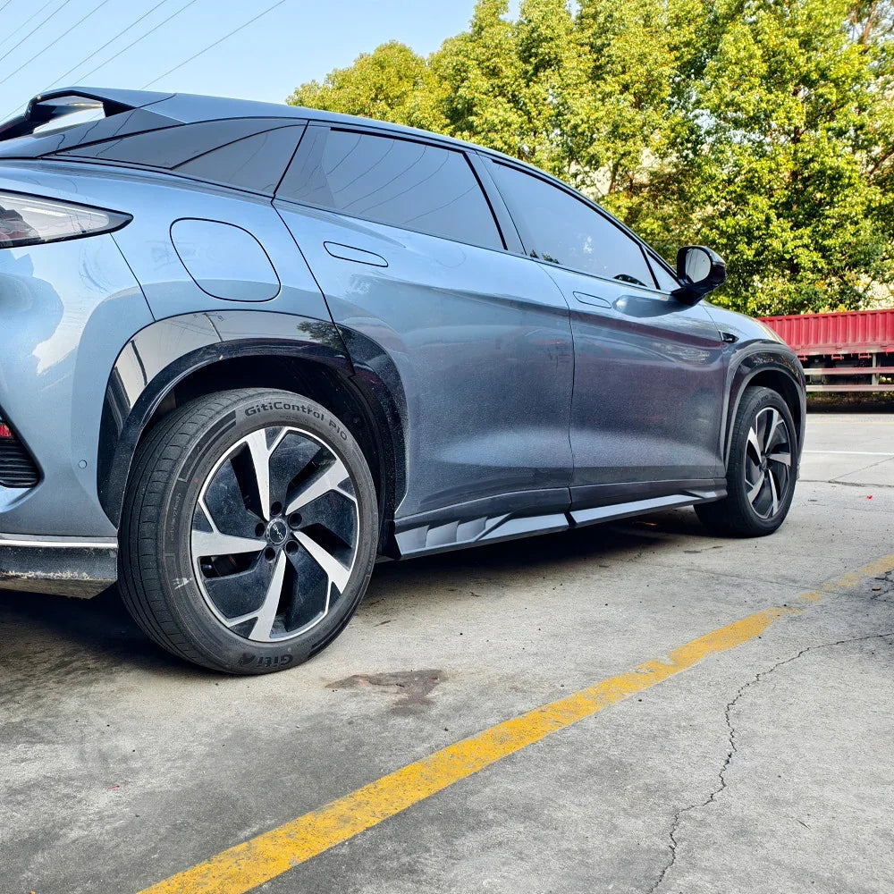 Side view of a sleek blue BYD electric SUV featuring stylish alloy wheels and aerodynamic body lines.