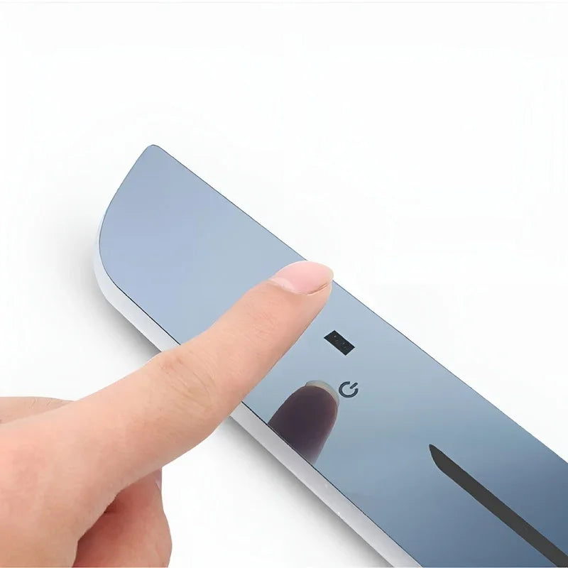 Finger pressing the power button on a sleek, blue metallic tempered glass car accessory panel.